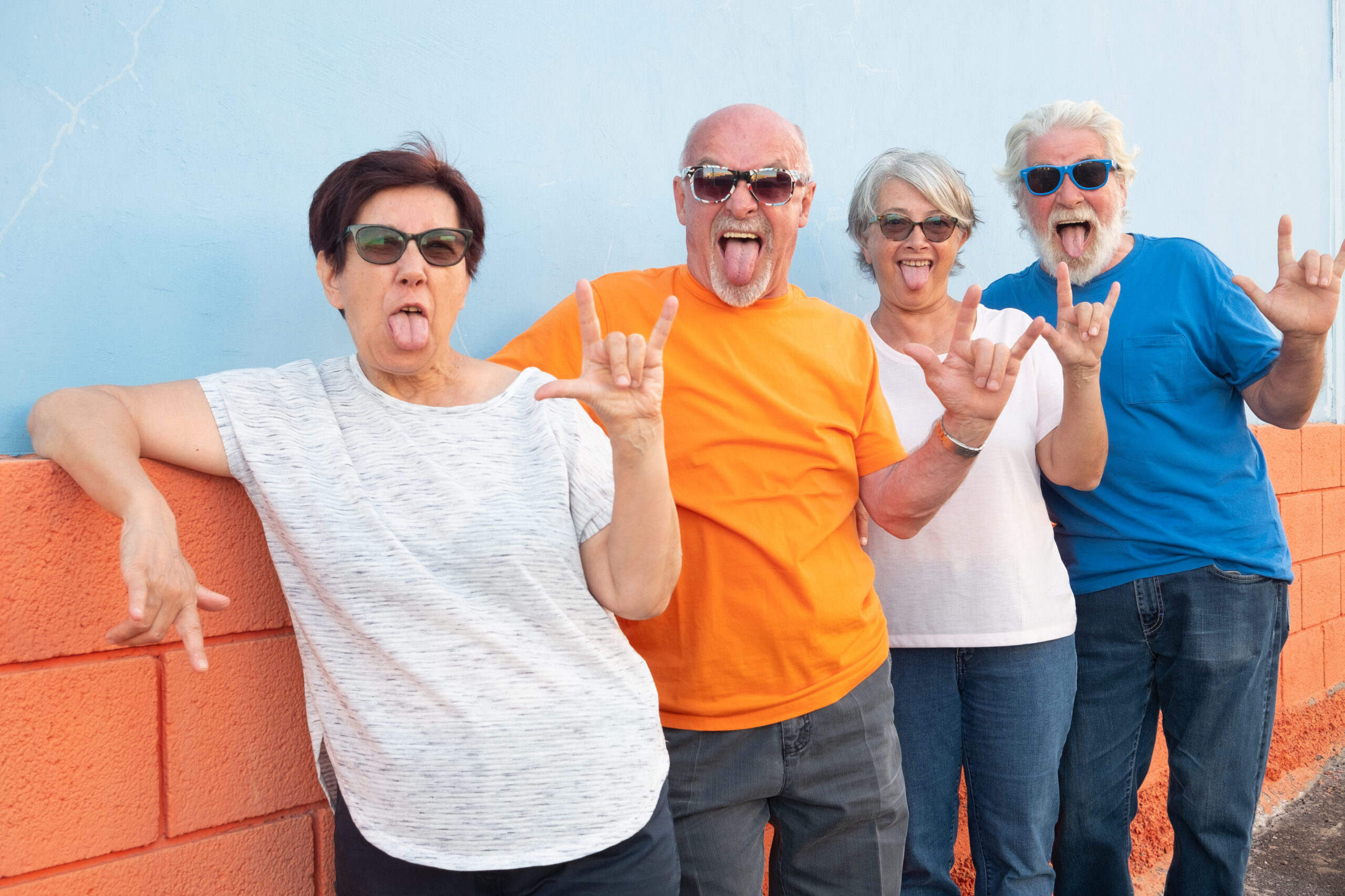 Crazy group of four senior people in friendship standing against